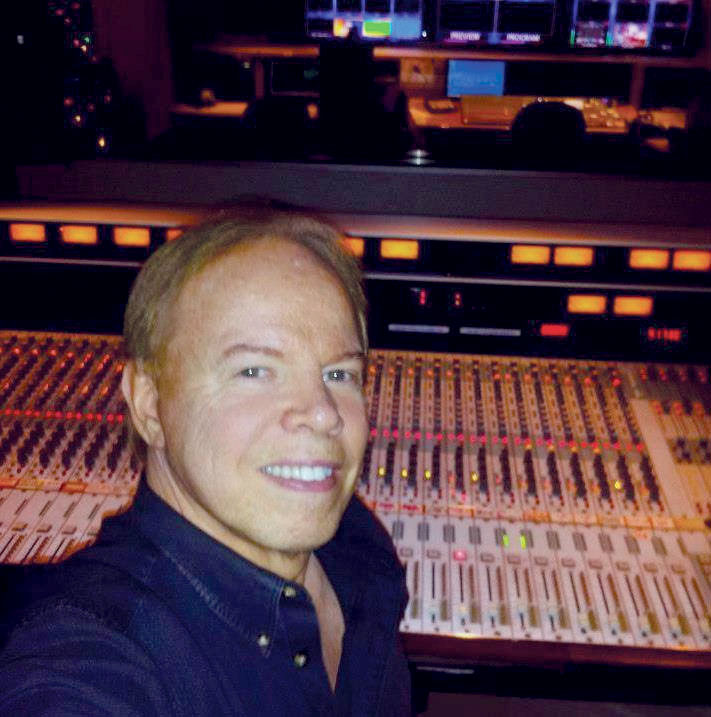 Gary Strickler, senior audio mixer for WCCB-TV’s evening news, in front of the station’s original TV80 audio console WCCB GaryStrickler TV80 Board